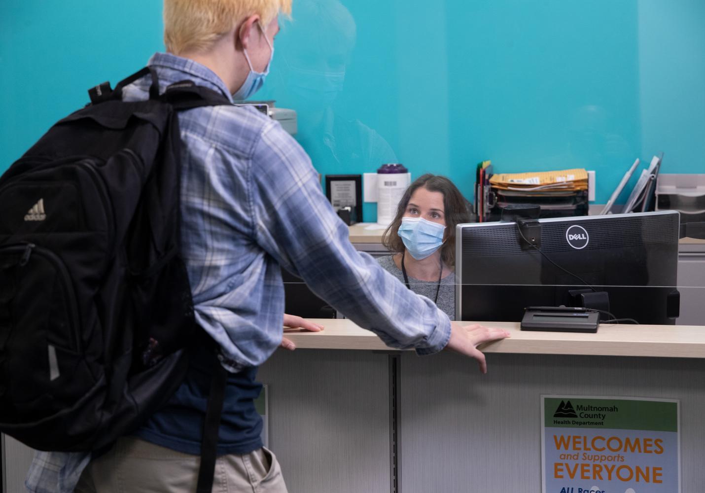 A young person checks in for a visit at a Student Health Center.