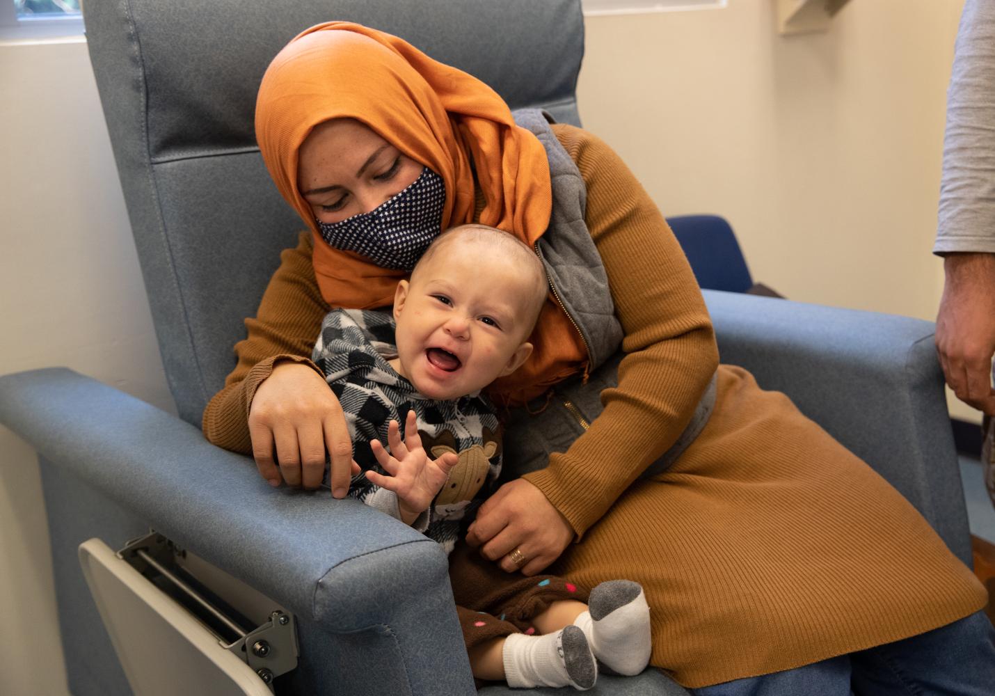 A baby and mother sit together at a health center.