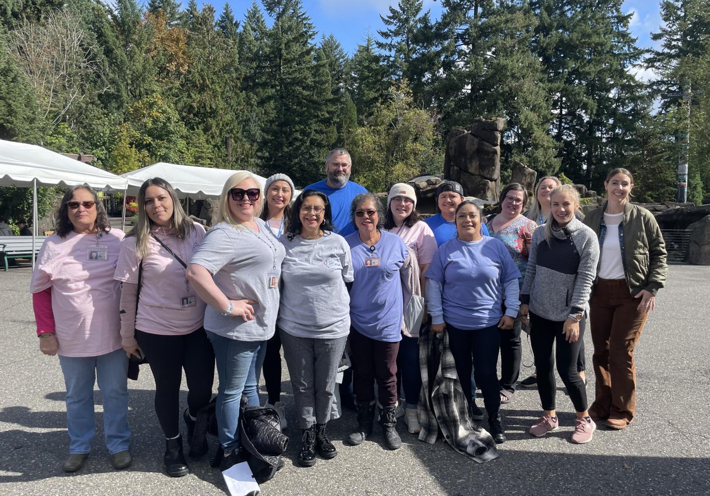 A group of Health Center leaders and community members stand together smiling.