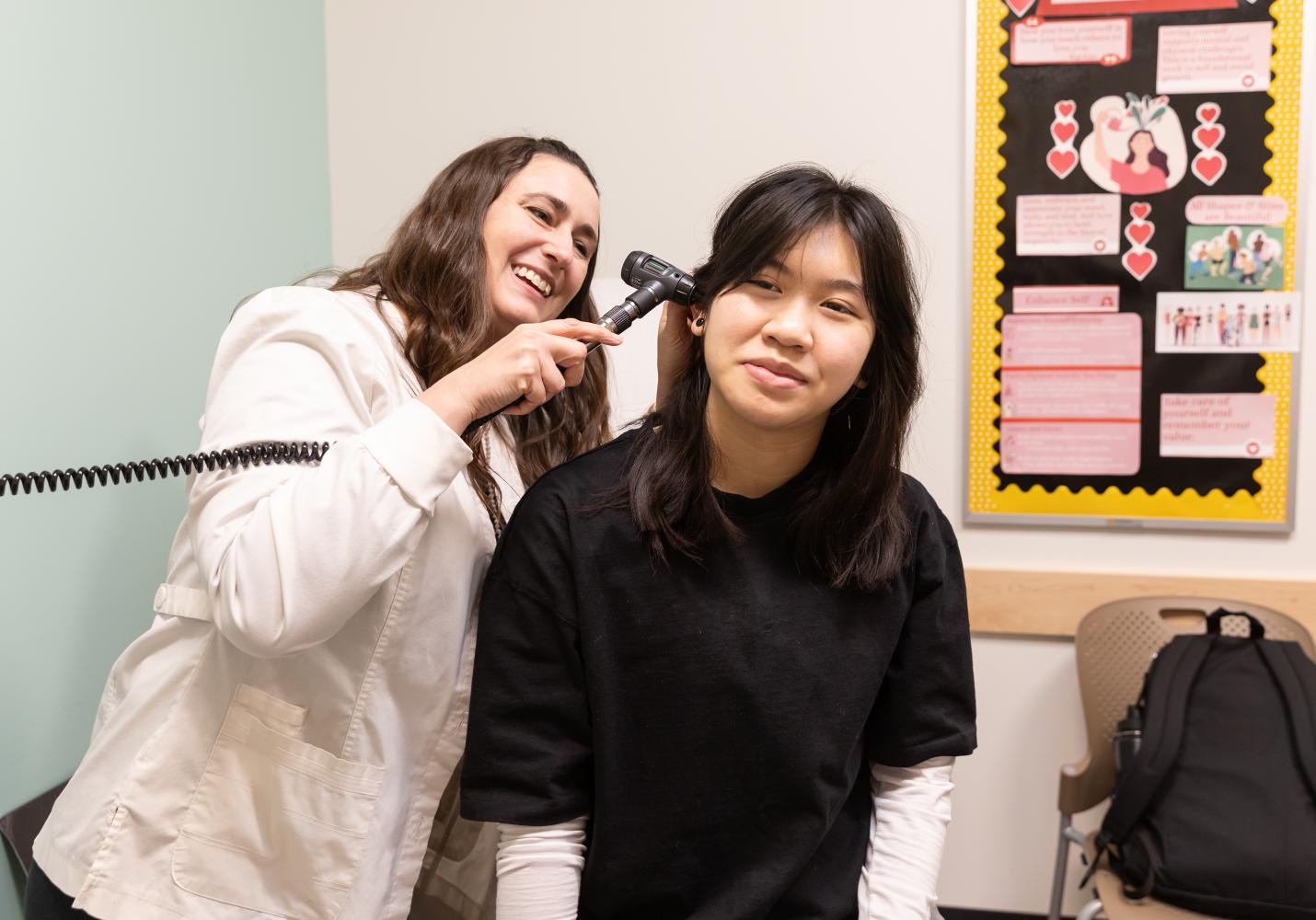 A provider gives a student an exam during a Student Health Center visit