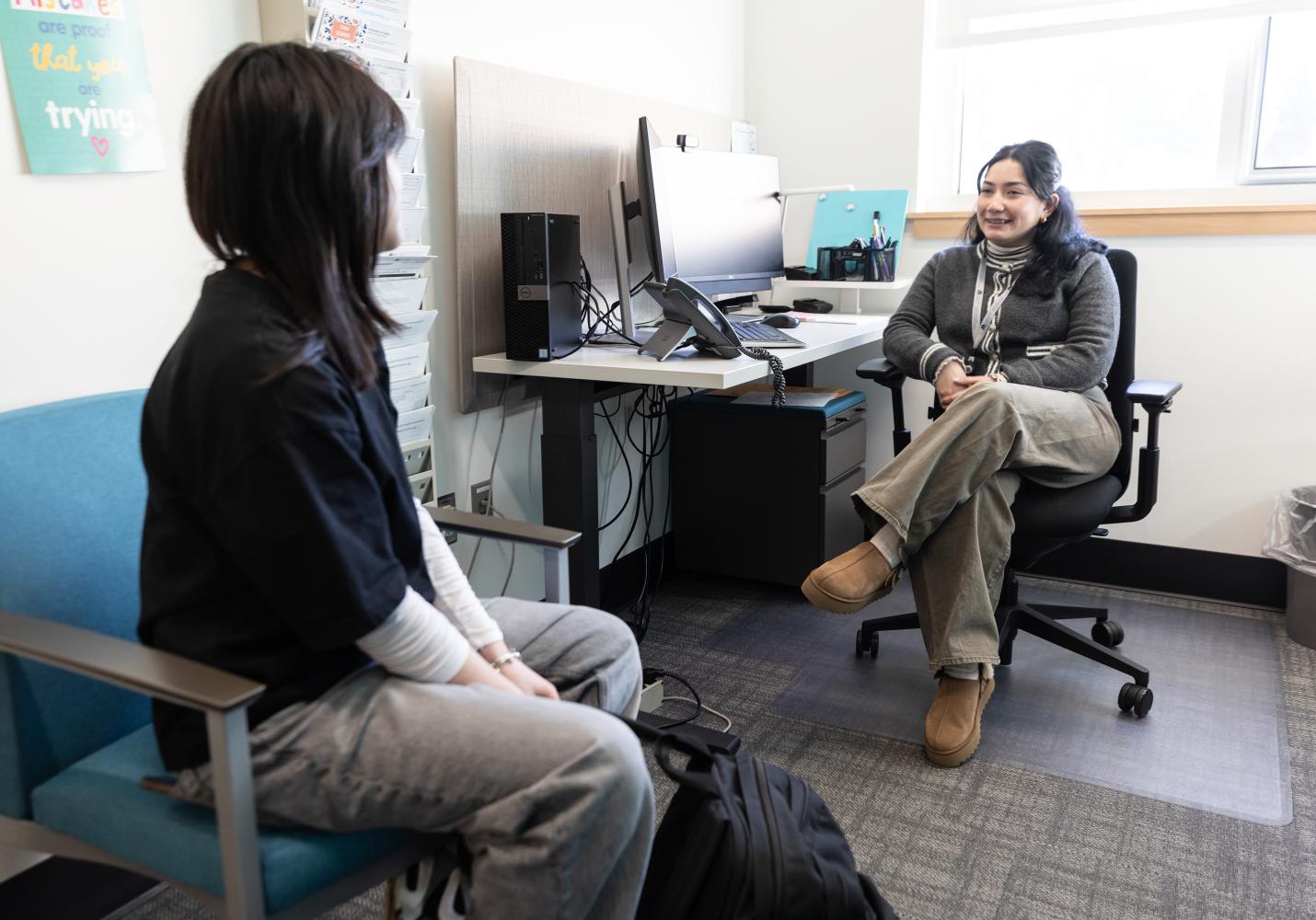 A Behavioral Health Team Member speaks with a patient